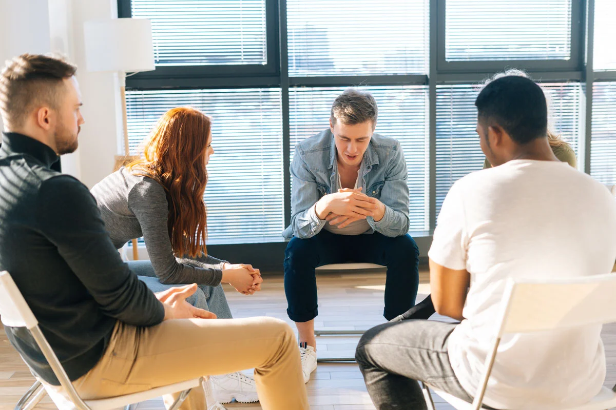 a therapy group meets within an outpatient addiction rehab program