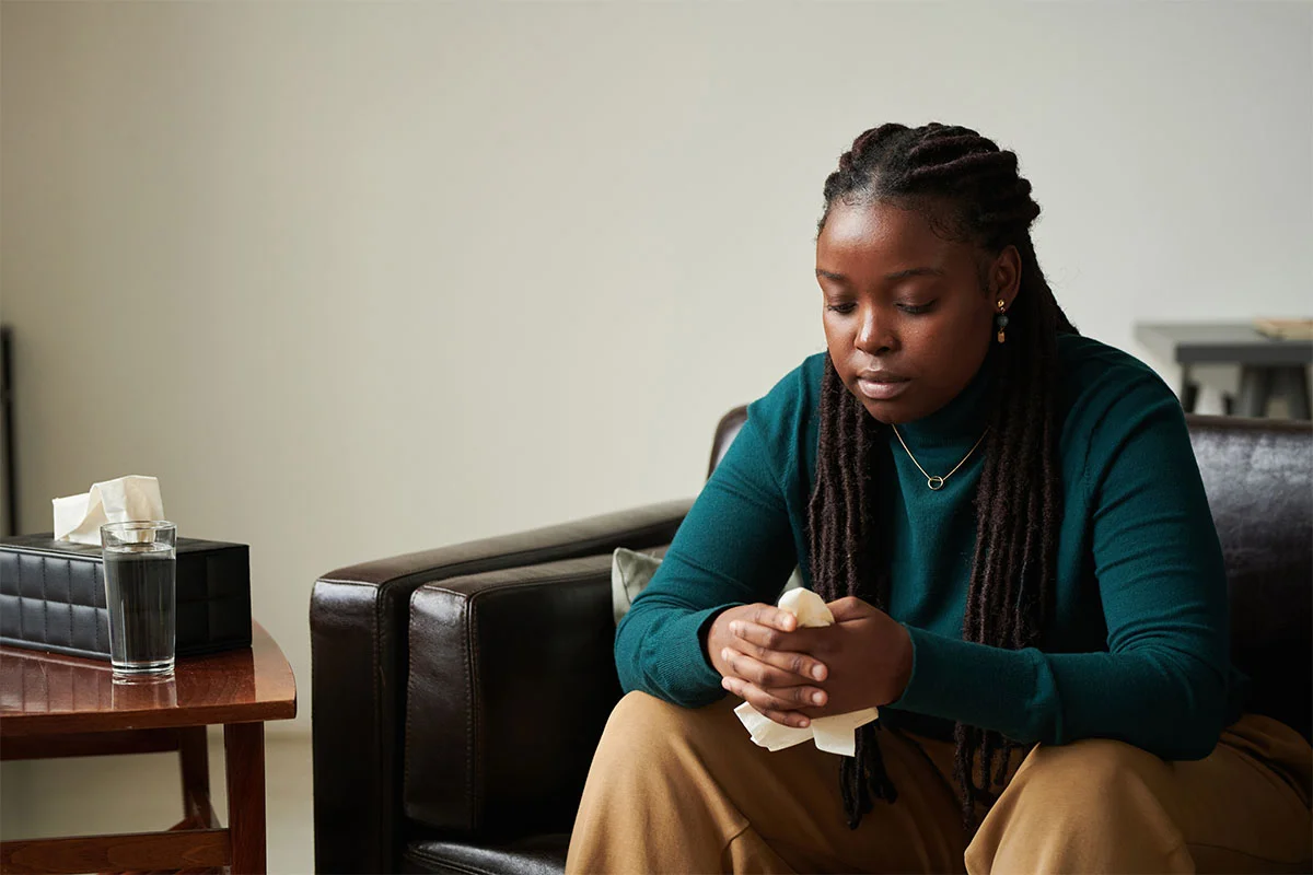 Sad woman holding tissue