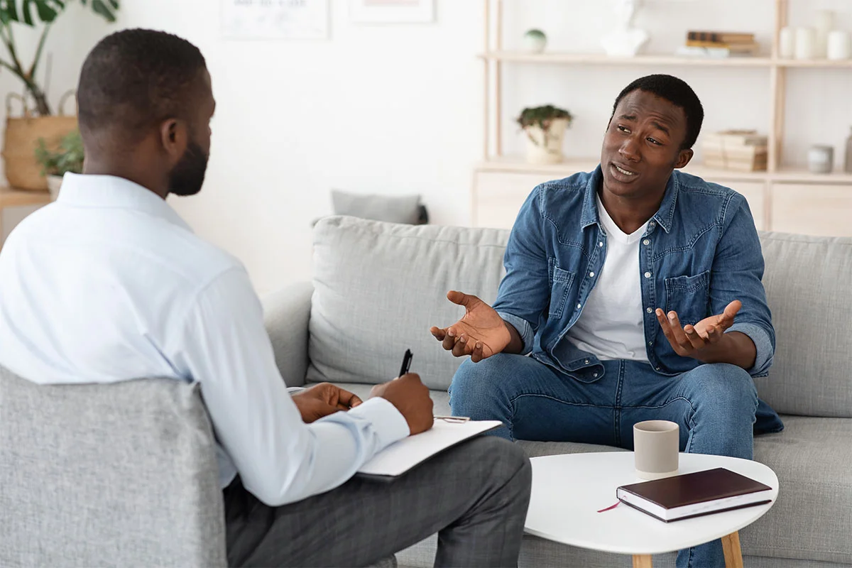Man shrugging in therapy session