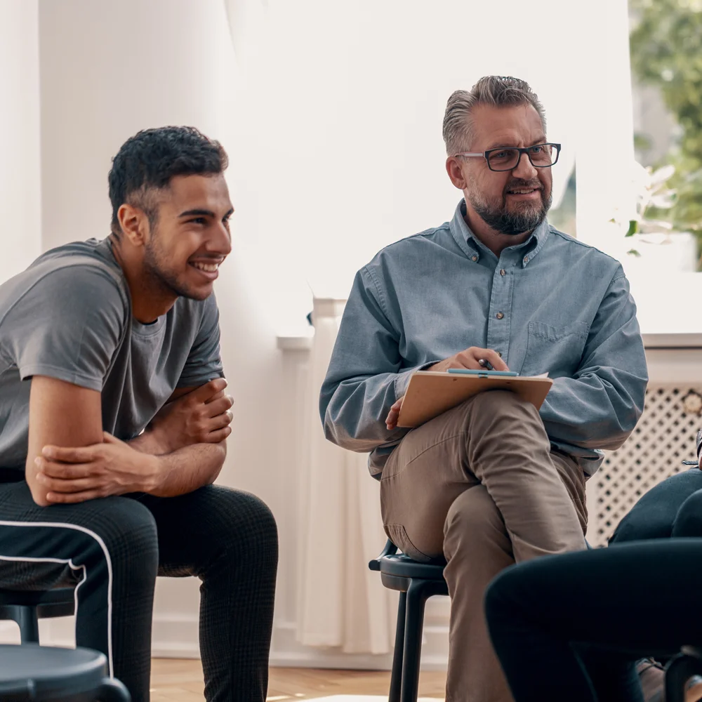 Two men listening in group therapy