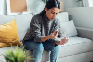 Woman on couch taking medication